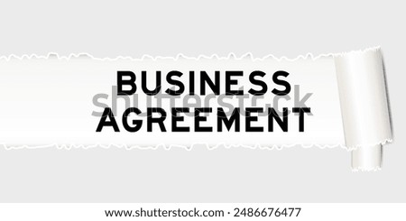 Ripped gray paper background that have word business agreement under torn part
