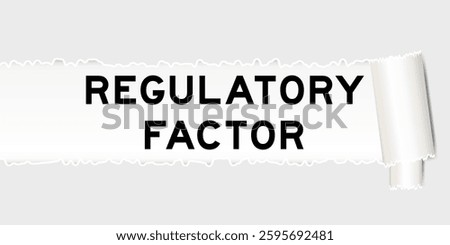 Ripped gray paper background that have word regulatory factor under torn part