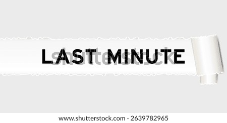 Ripped gray paper background that have word last minute under torn part