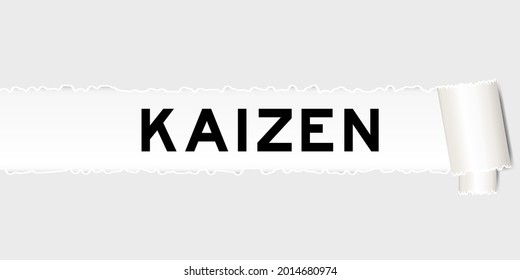Ripped gray paper that have word kaizen under torned part