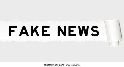 Ripped gray paper that have word fake news under torned part