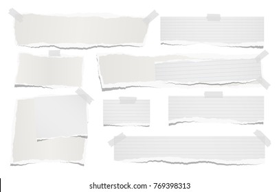 Ripped lined and blank note, notebook paper strips for text or message stuck with sticky tape on white background