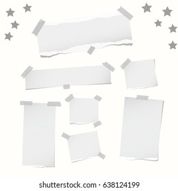 Ripped note, notebook, copybook paper strips, stars, stuck with sticky tape on white background.