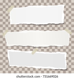 Ripped note, notebook paper strips stuck on spotted brown squared background.