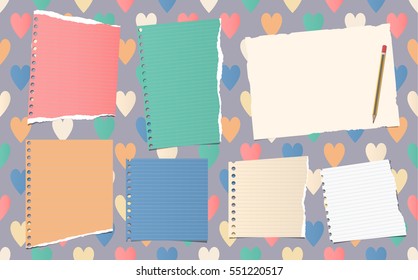 Ripped ruled notebook, copybook, note paper strips with pencil stuck on pattern created of colorful heart shapes