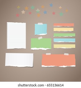 Ripped white and colorful note, notebook, copybook paper strips stuck with sticky tape, stars on brown background.