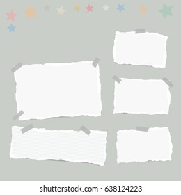 Ripped white note, notebook, copybook paper sheets, stars, stuck with sticky tape on gray background.