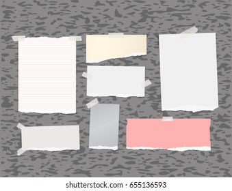 Ripped white note, notebook, copybook paper strips stuck with sticky tape gray background.