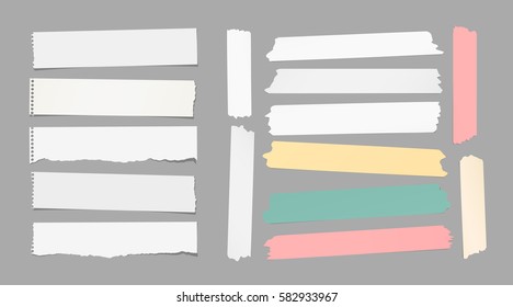 Ripped white notebook, copybook, note paper strips, colorful sticky, adhesive masking tape stuck on gray background