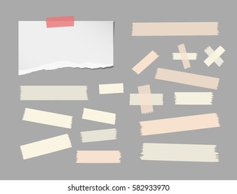 Ripped white notebook, copybook, note paper strip, brown sticky, adhesive masking tape stuck on gray background