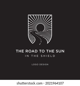 THE ROAD TO THE SUN IN THE SHIELD LOGO