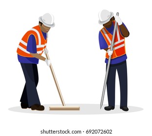 Road workers in orange uniform and safety helmets standing in working poses 