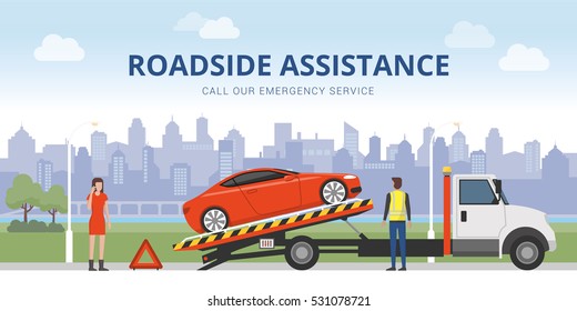 Roadside assistance and car insurance concept: broken car on a tow truck and woman calling emergency services