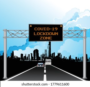 Roadway overhead digital gantry sign with COVID 19 Coronavirus lockdown zone message set against a blue cloudy sky 