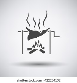 Roasting meat on fire icon on gray background with round shadow. Vector illustration.
