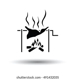 Roasting meat on fire icon. White background with shadow design. Vector illustration.
