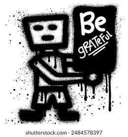 robot graffiti sprayed with black paint while holding a poster that says be grateful