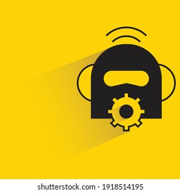 robot head and gear with shadow on yellow background