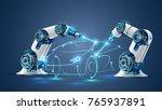 Robot welder in automobile industry. White robots welding car body on automobile factory. The robots draw the outline of the concept car with a laser ray or beam. 