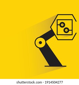 robotic arm picking microchip on yellow background