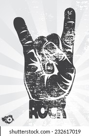 Rock hand gesture on a gray background