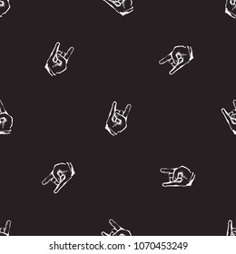 Rock and roll seamless pattern with rock gesture. Vector hard rock doodle illustration. Cartoon rock star iconic backdrop for music band, concert, party. Isolated on black background.