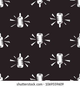 Rock and roll seamless pattern with microphone. Vector hard rock doodle illustration. Cartoon rock star iconic backdrop for music band, concert, party. Isolated on black background.