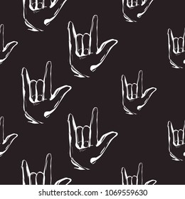 Rock and roll seamless pattern with rock'n'roll gesture. Vector hard rock doodle illustration. Cartoon rock star iconic backdrop for music band, concert, party. Isolated on black background.