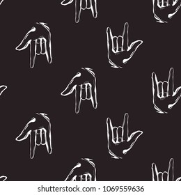 Rock and roll seamless pattern with rock'n'roll gesture. Vector hard rock doodle illustration. Cartoon rock star iconic backdrop for music band, concert, party. Isolated on black background.