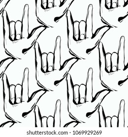Rock and roll seamless pattern with rock'n'roll gesture. Vector hard rock doodle illustration. Cartoon rock star iconic backdrop for music band, concert, party. Isolated on black background.