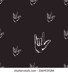 Rock and roll seamless pattern with rock'n'roll gesture. Vector hard rock doodle illustration. Cartoon rock star iconic backdrop for music band, concert, party. Isolated on black background.