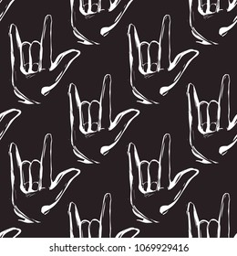 Rock and roll seamless pattern with rock'n'roll gesture. Vector hard rock doodle illustration. Cartoon rock star iconic backdrop for music band, concert, party. Isolated on black background.