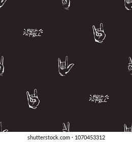 Rock and roll seamless pattern with rock'n'roll text sign, peace and rock gestures. Vector hard rock doodle illustration. Cartoon rock backdrop for music band, concert, party with black background.