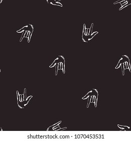 Rock and roll seamless pattern with rock'n'roll gesture. Vector hard rock doodle illustration. Cartoon rock star iconic backdrop for music band, concert, party. Isolated on black background.