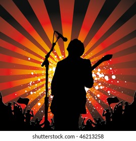 rock singer with a guitar singing to the crowd of fans
