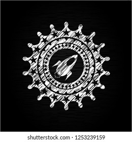 rocket icon drawn on a blackboard