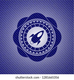 rocket icon inside badge with denim background