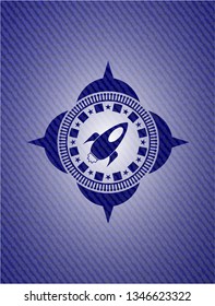 rocket icon inside badge with denim texture