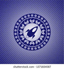 rocket icon inside badge with denim background