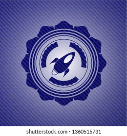 rocket icon inside badge with jean texture