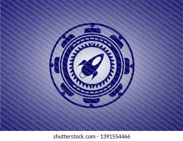 rocket icon inside badge with jean texture