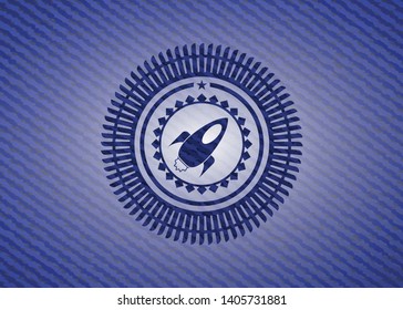 rocket icon inside badge with jean texture