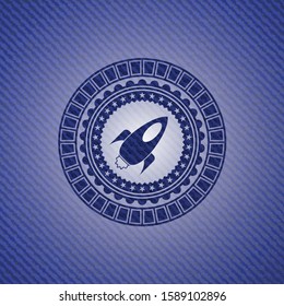 rocket icon inside badge with jean texture