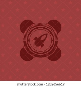 rocket icon inside badge with red background