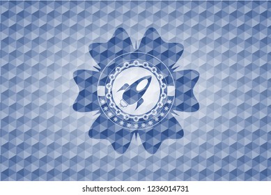 rocket icon inside blue emblem or badge with geometric pattern background.