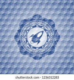 rocket icon inside blue emblem or badge with abstract geometric pattern background.