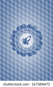 rocket icon inside blue emblem or badge with geometric pattern background.