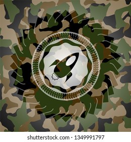 rocket icon inside camouflage emblem