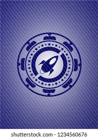 rocket icon inside denim background