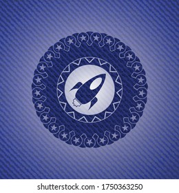 rocket icon inside denim background. 